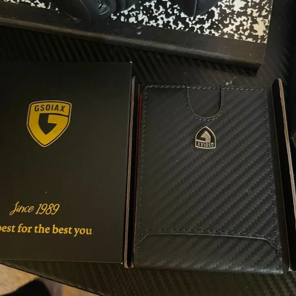 Men’s carbon fiber style wallet with bright red interior.